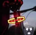 Pack Seguridad Total con luz trasera para bicicleta, carcasa negra y señales luminosas rojas y amarillas intermitentes.